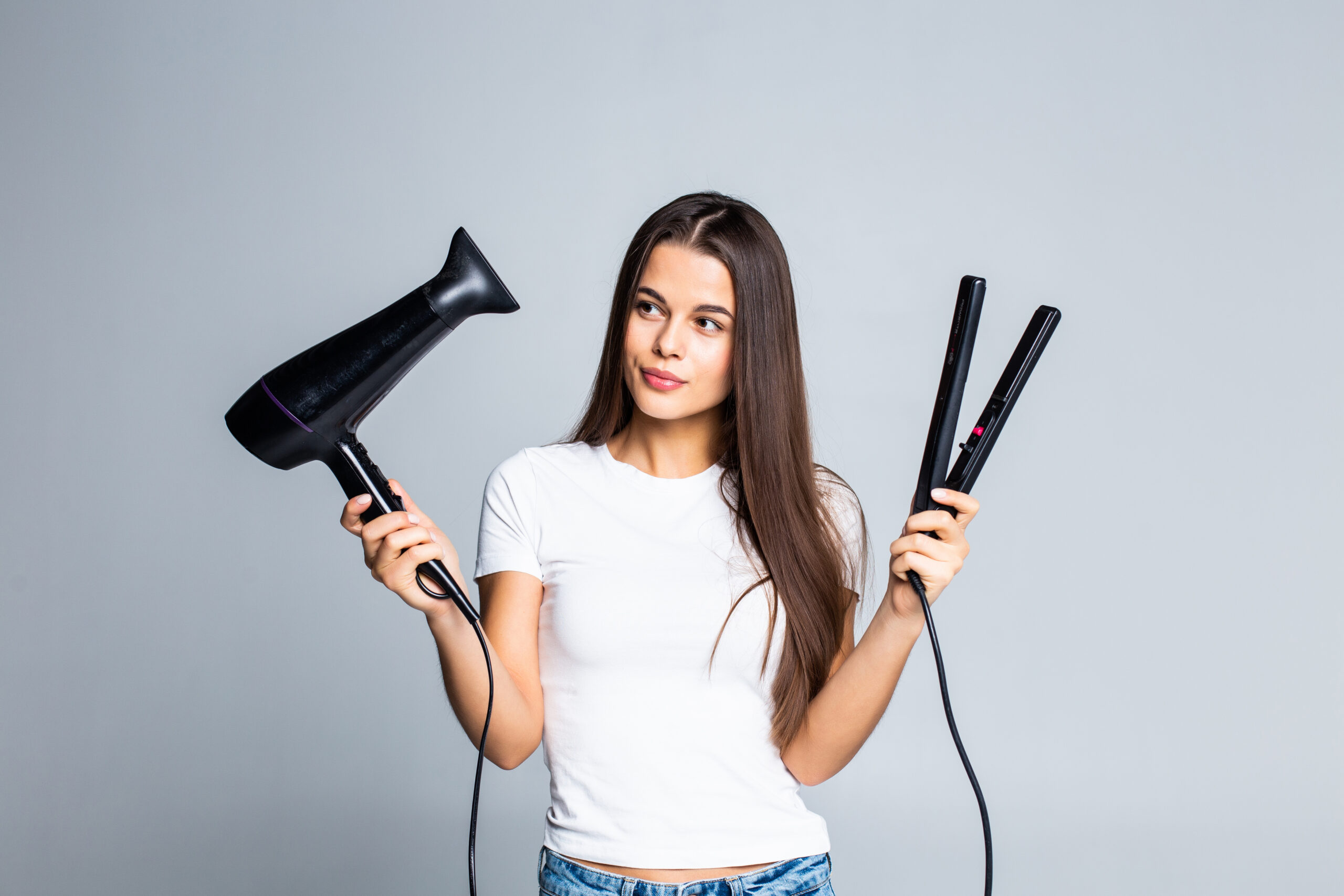 Atasi Rambut Kering Dengan 5 Cara Sederhana Ini! 6 young pretty woman holding hair dryer straightening isolated white scaled
