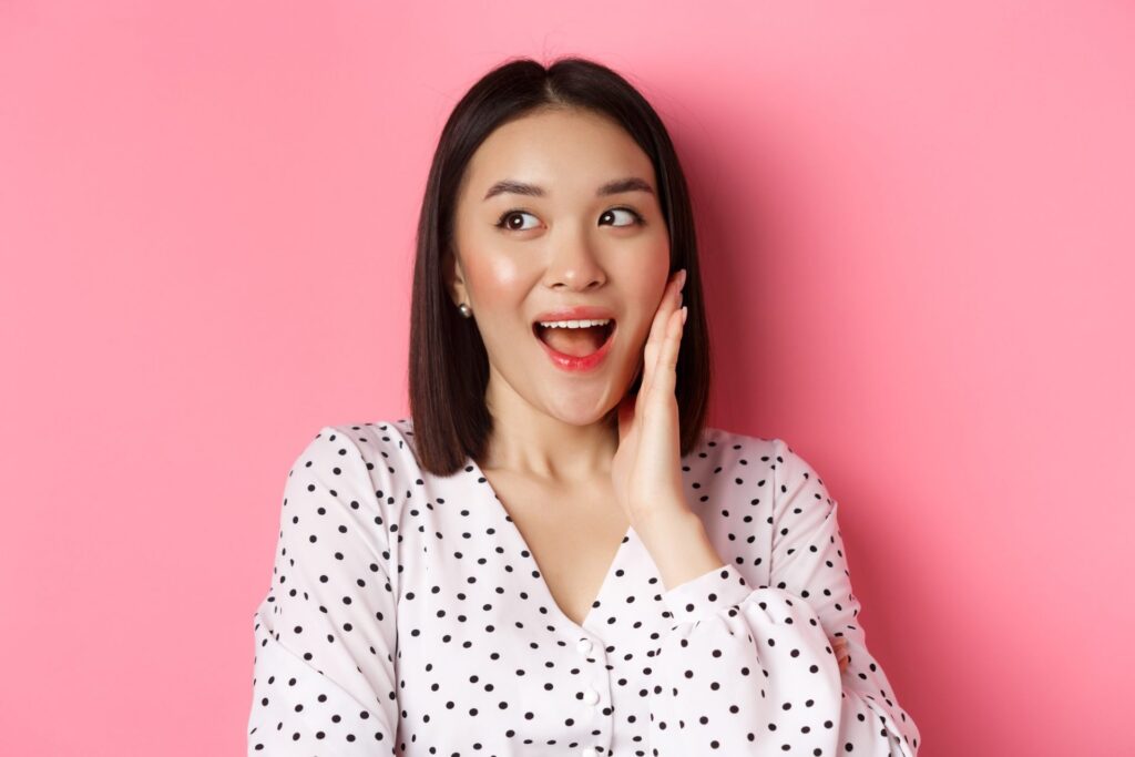 10 Manfaat Tanaman Kumis Kucing yang Jarang Orang Tahu! 8 coquettish asian woman blushing touching cheek looking left amused standing pink background