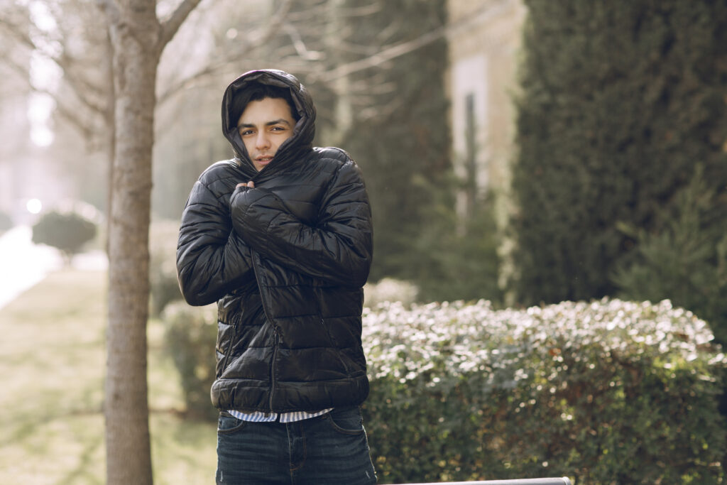 man feeling cold black winter jacket park high quality photo