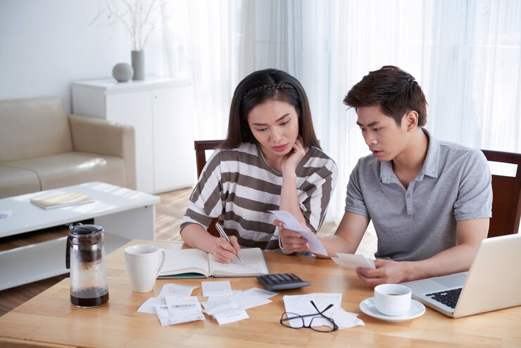 man woman calculating domestic budget home 1098 18991