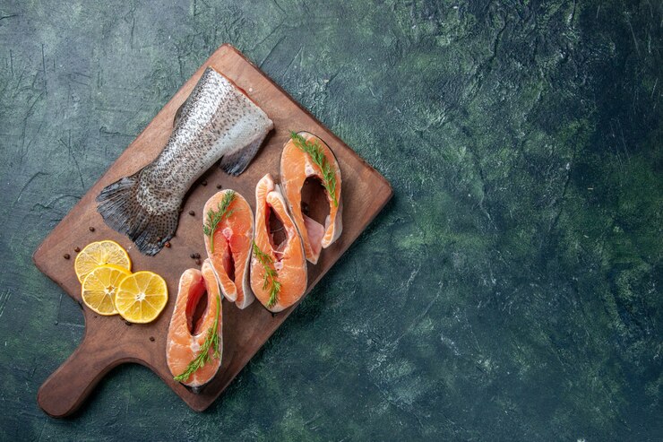 Ini Dia 7 Makanan Terbaik untuk Tingkatkan Kecerdasan Otak! 2 top view raw fishes lemon slices greens pepper wooden cutting board dark table 179666 18214