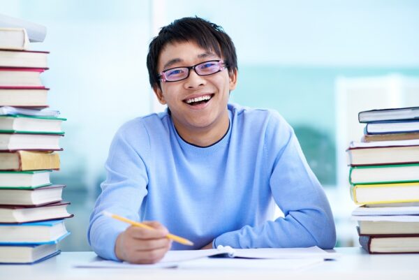 student sitting desk with books table