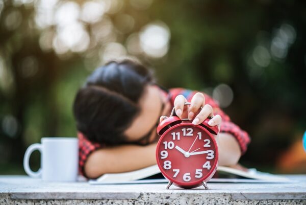 young girl lying down desk after reading book
