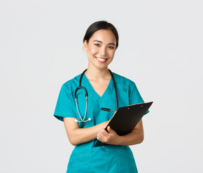 healthcare workers preventing virus quarantine campaign concept cheerful friendly asian female physician doctor with clipboard during daily checkup standing white background