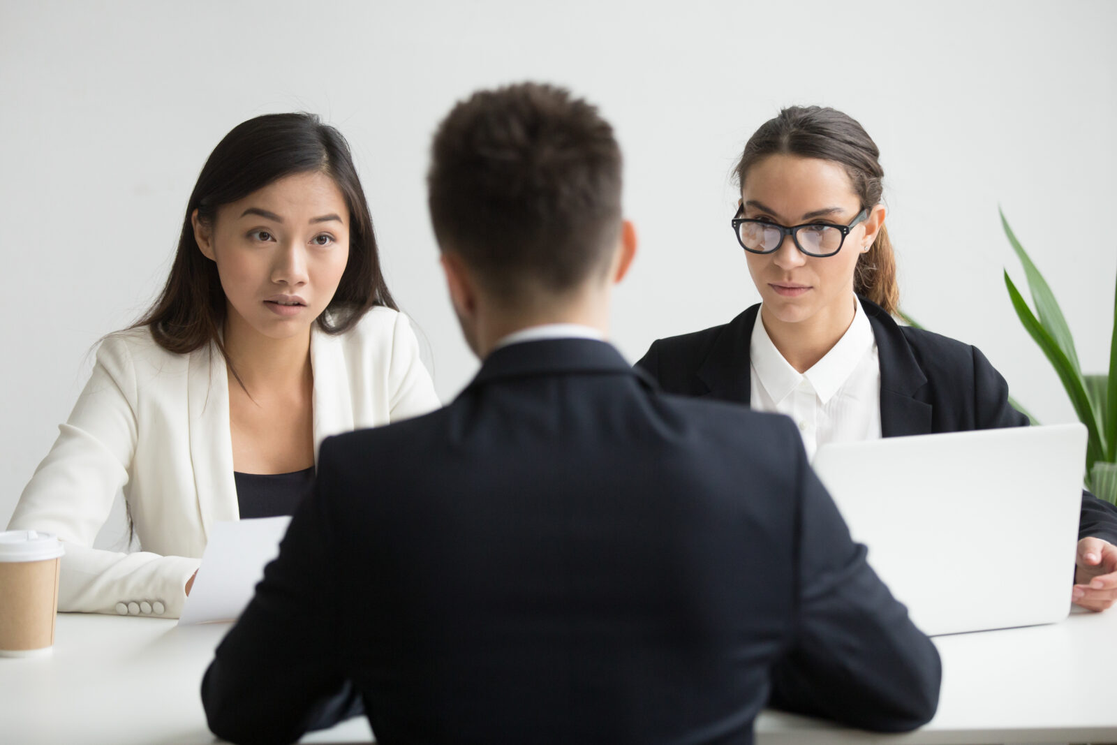 serious unconvinced diverse hr managers interviewing male job applicant