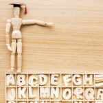 20230622082213 fpdl.in top view wooden figurine with academic cap alphabet 23 2148756554 large