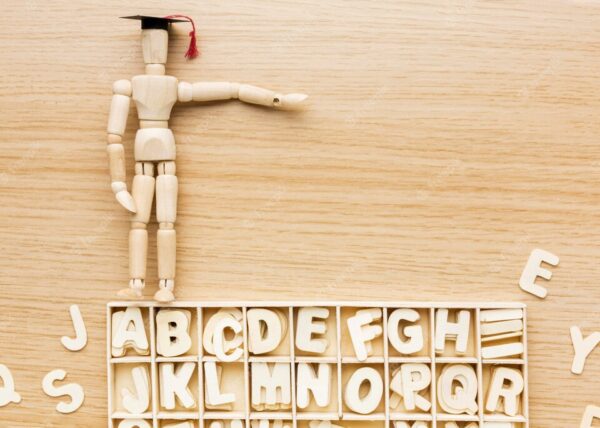 20230622082213 fpdl.in top view wooden figurine with academic cap alphabet 23 2148756554 large