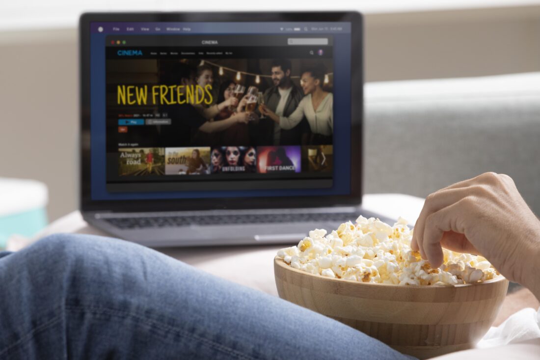 man watching streaming service his laptop