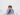 tired sleepy asian young business man glasses with head hands sitting sleeping workplace table white wall