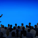 corporate businessman giving presentation large audience