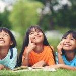 Hari Anak Nasional : Fakta, Sejarah, Makna Logonya dan Link Download Desain Grafisnya 5 group children lying reading grass field