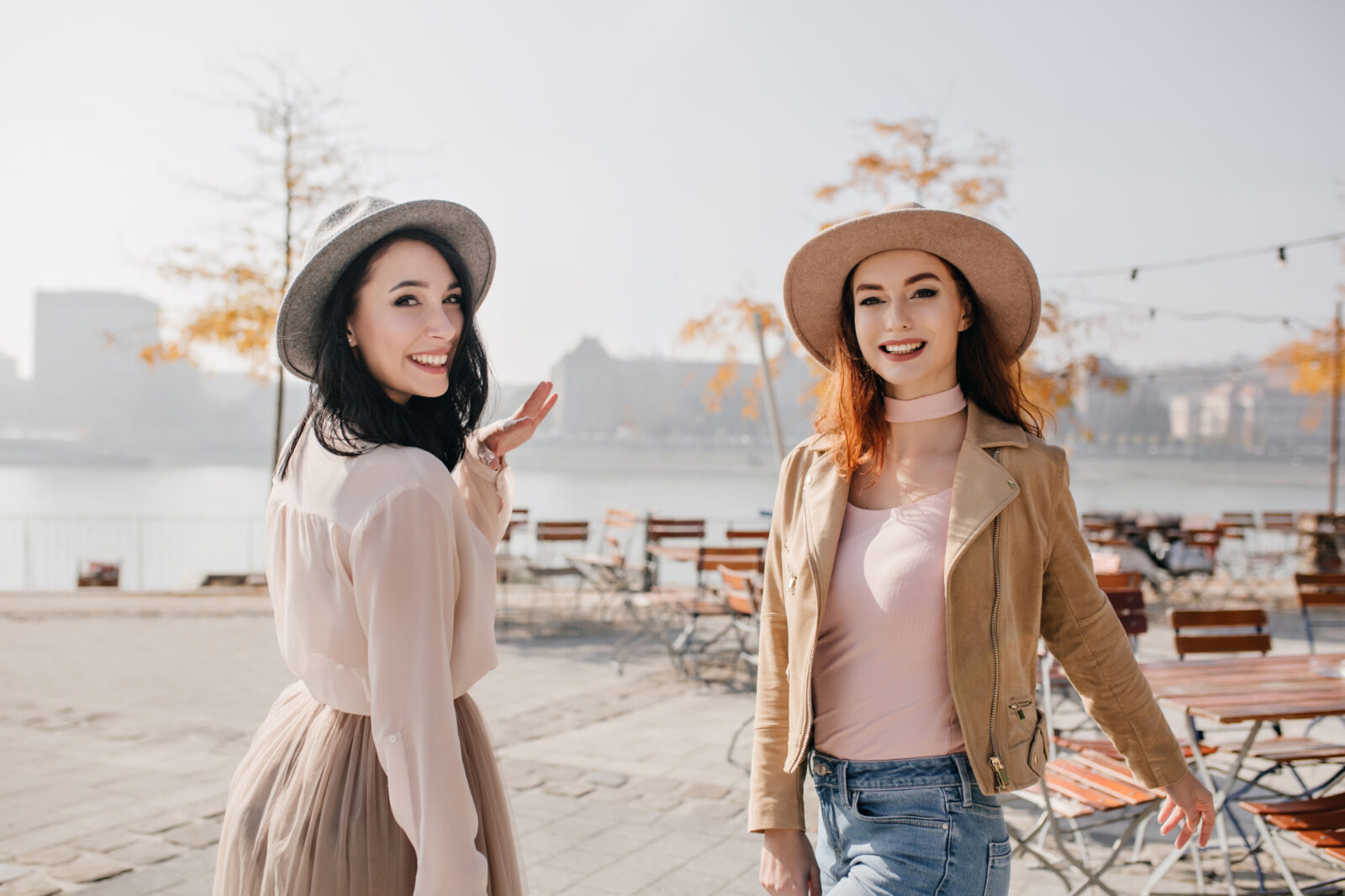 inspired woman white blouse looking shoulder with smile walking with ginger friend