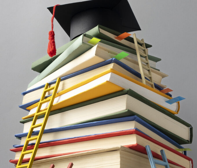 low angle stacked books graduation cap ladders education day
