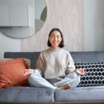 Aktivitas Seru Untuk Akhir Pekan 5 relaxation patience smiling young asian woman cozy room sitting sofa meditating doing