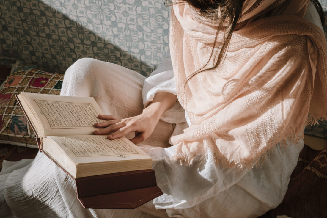 sitting woman reading quran