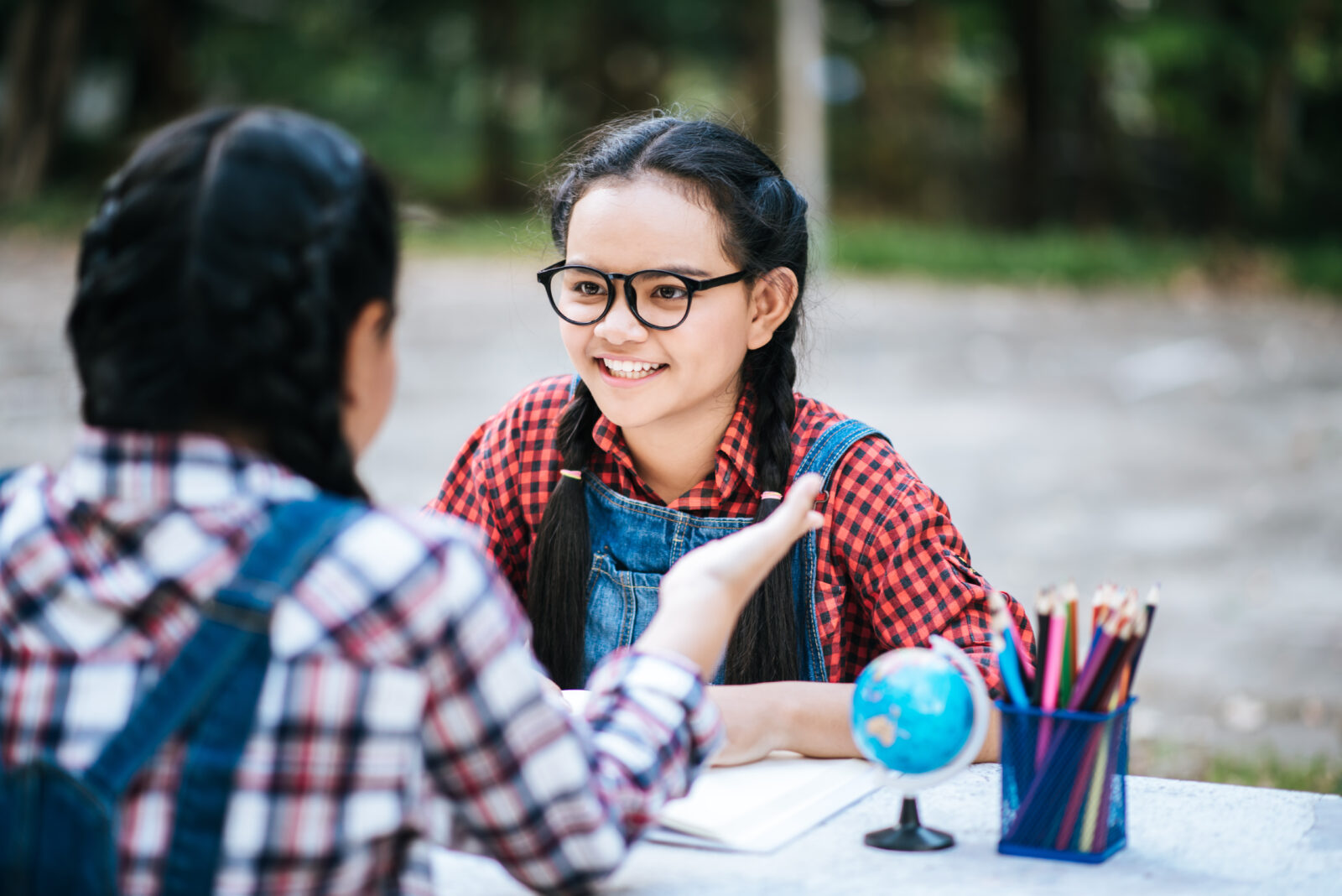 two study girl talking each other park