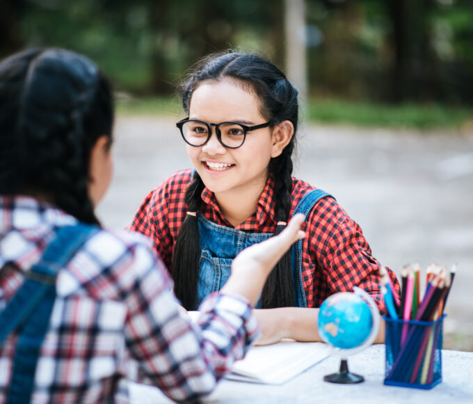 two study girl talking each other park