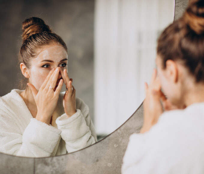 woman home applying cream mask