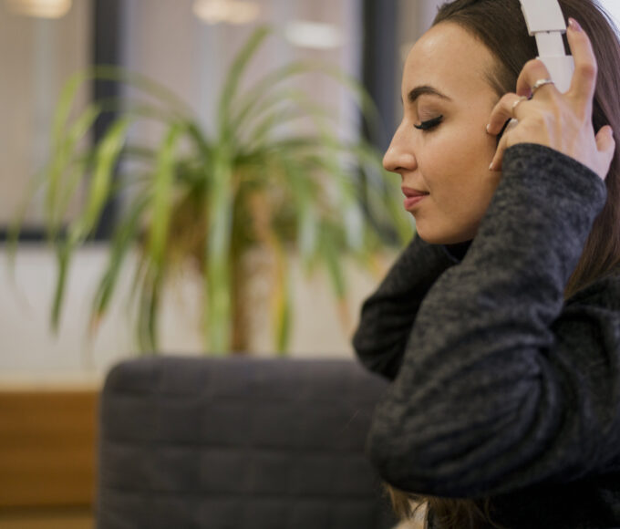 woman putting headphones head