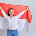 Kemerdekaan Indonesia: Mencapai Puncak Potensi dan Teruslah Bertumbuh 3 20230818091243 fpdl.in happy young asian women celebrate indonesian independence day holding indonesian flag isolated white background 512242 4283 large