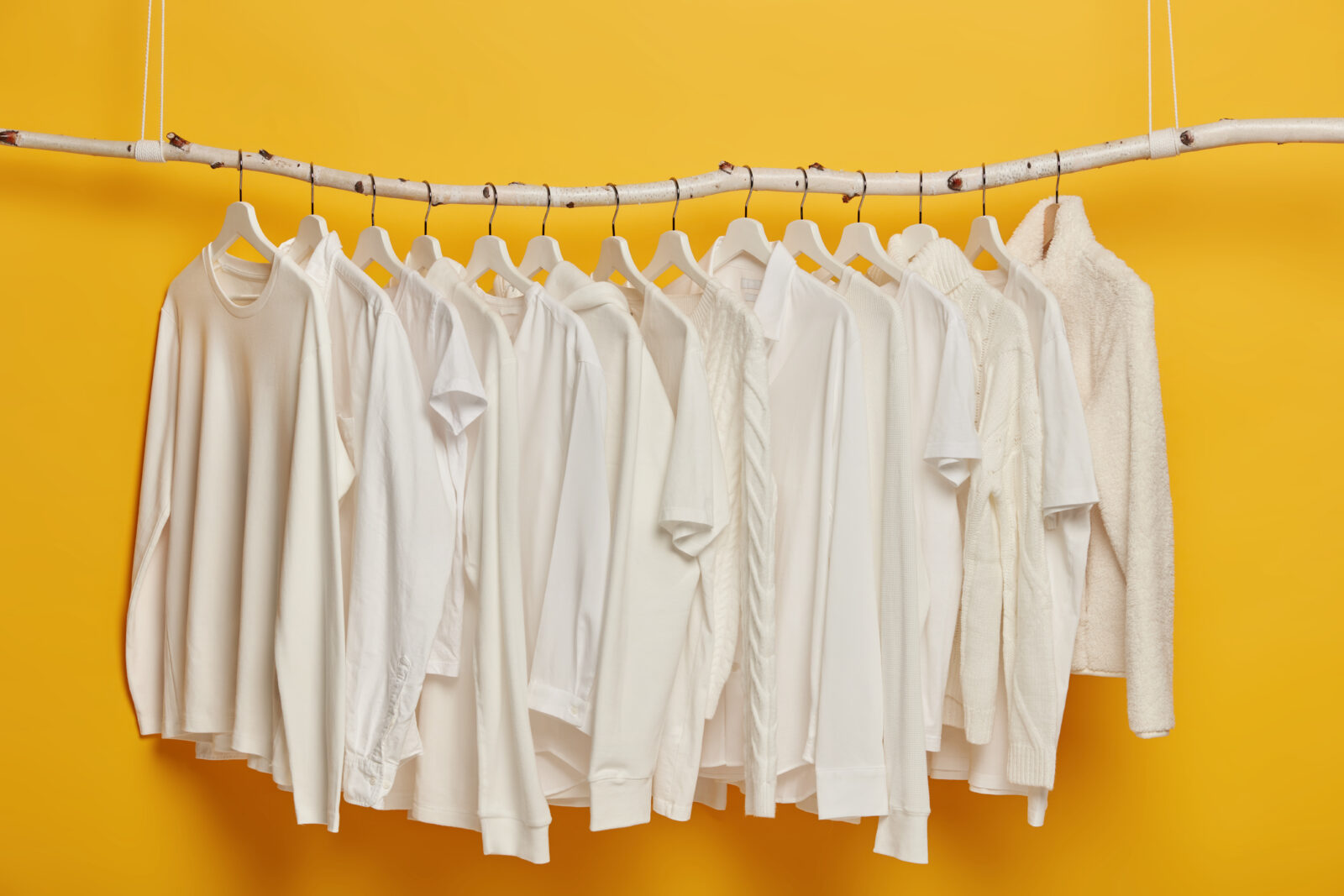 Tips & Trik Agar Baju Rapih Tanpa Di Setrika 1 group white plain clothes hanging garment rack rail minimalistic concept apparel women isolated yellow background