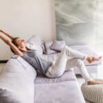 smiling young woman relax lying couch