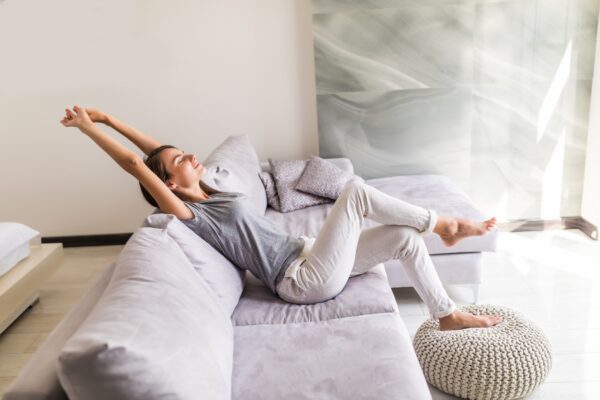 smiling young woman relax lying couch