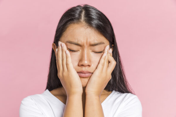 woman keeping her head palms