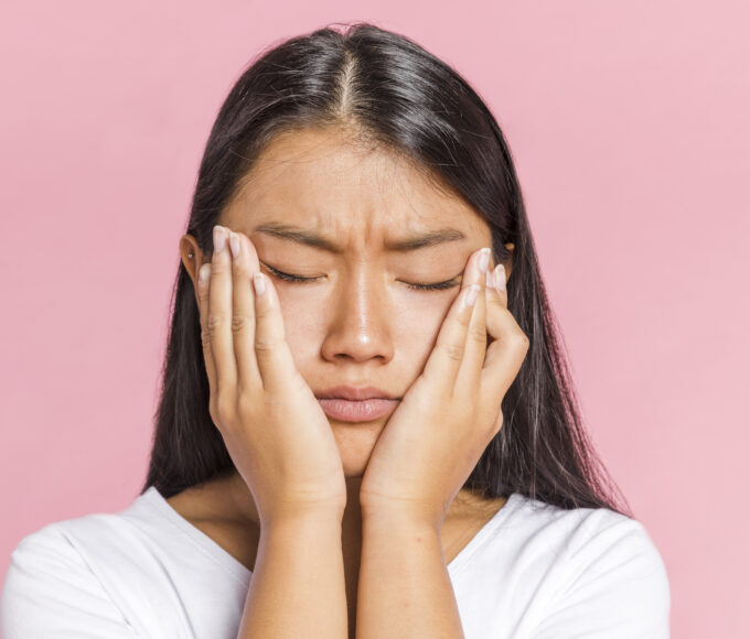 woman keeping her head palms