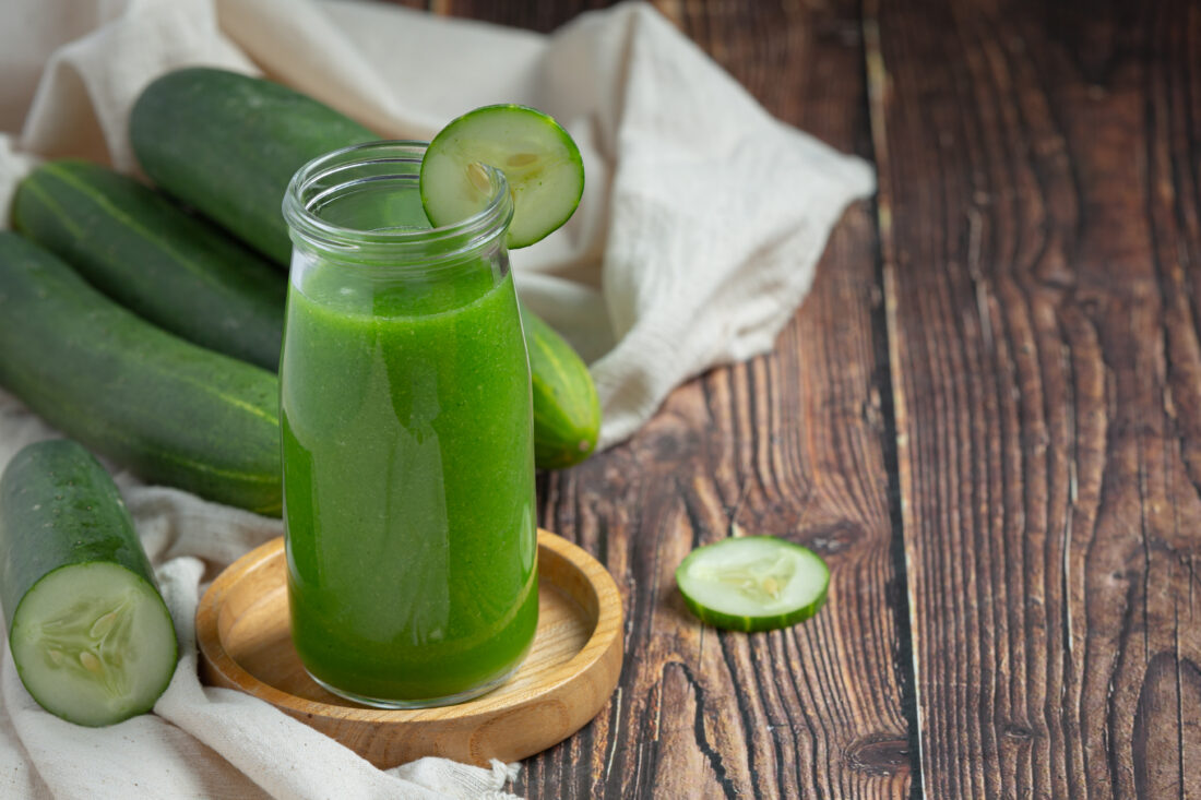 fresh cucumber juice jar dark wood background