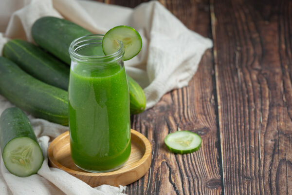fresh cucumber juice jar dark wood background