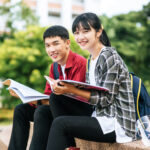 Berikut Adalah Kriteria Siswa yang Bisa Daftar Beasiswa Indonesia Maju Angkatan 4 3 male female students sitting reading books stairs
