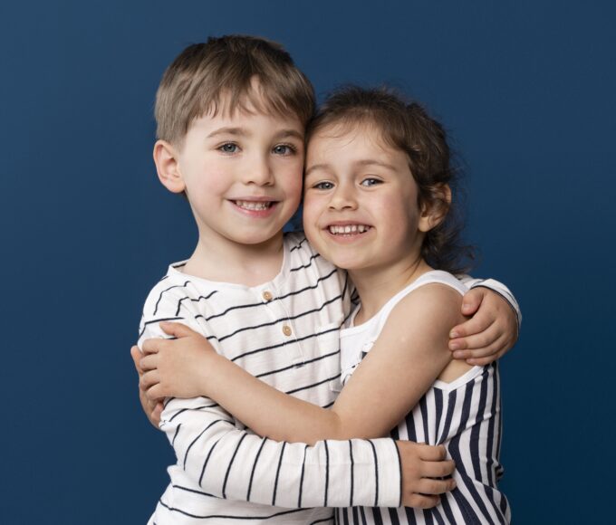 smiley little kids holding each other
