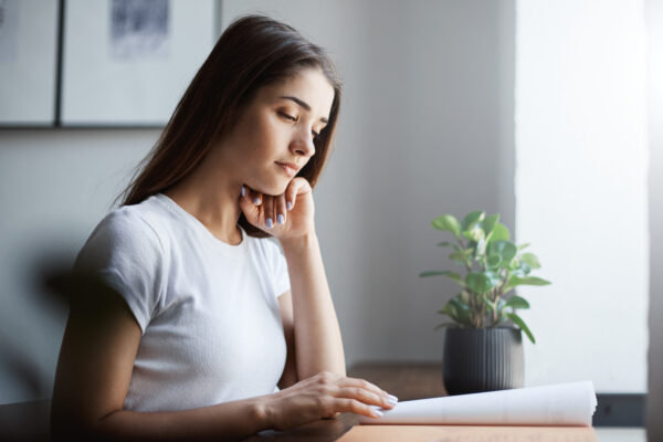 young english student learning language using offline work book concentrated reading memorizing