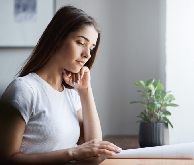 young english student learning language using offline work book concentrated reading memorizing