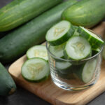 fresh cucumbers sliced dark background