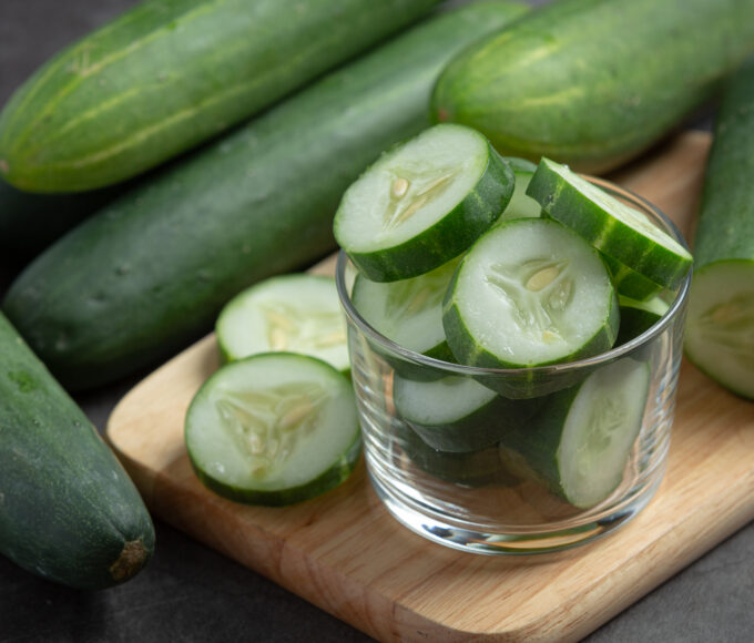fresh cucumbers sliced dark background
