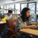 side view students learning together