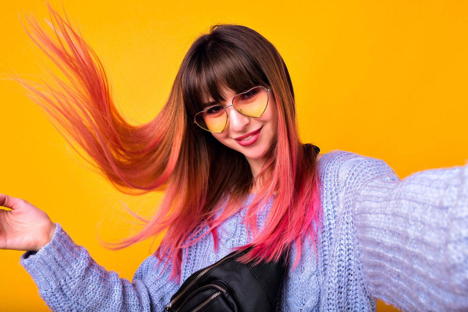 happy woman with unusual pink hairs making selfie yellow wall stylish cozy sweater hearted vintage sunglasses