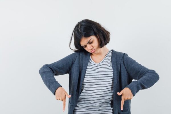 little girl pointing down t shirt jacket looking focused 176474 19084