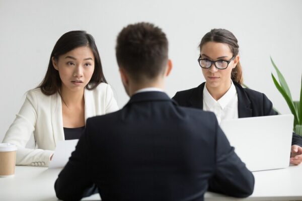 serious unconvinced diverse hr managers interviewing male job applicant 1163 4675