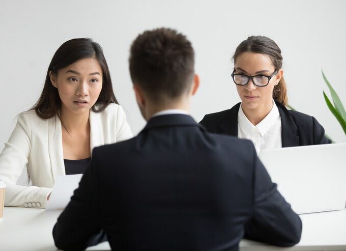 serious unconvinced diverse hr managers interviewing male job applicant 1163 4675